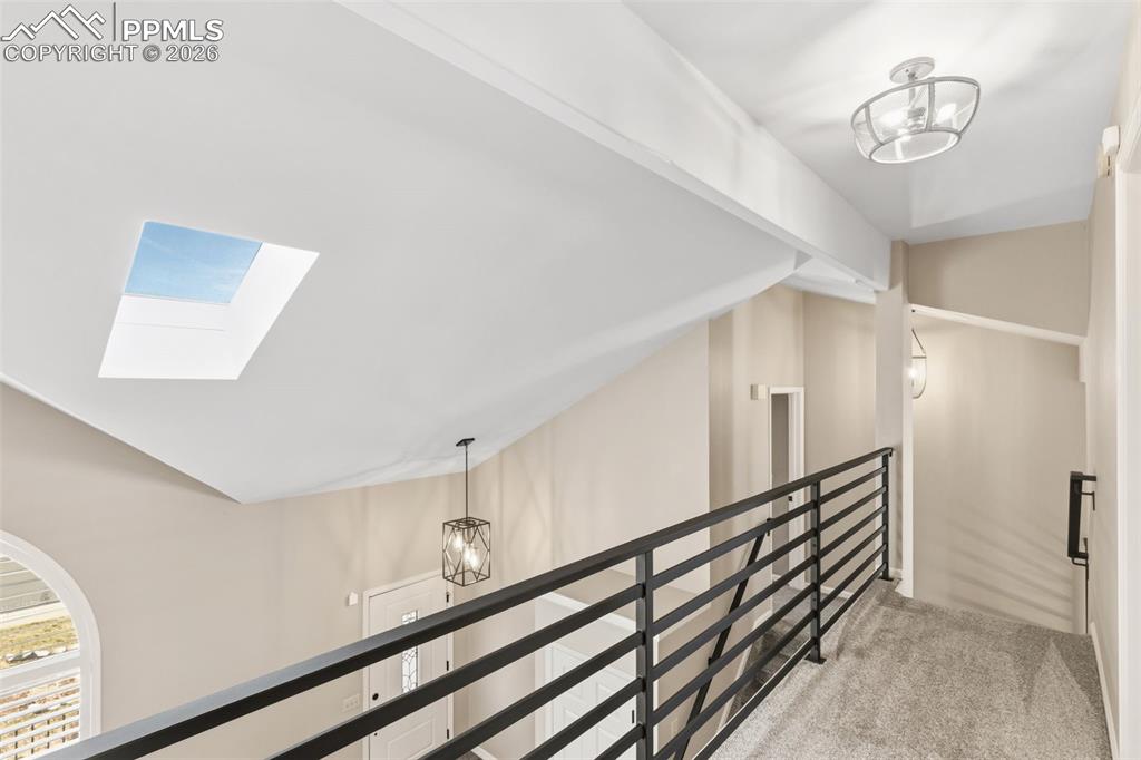 Image 30 of 49: open upper hall with custom railing.