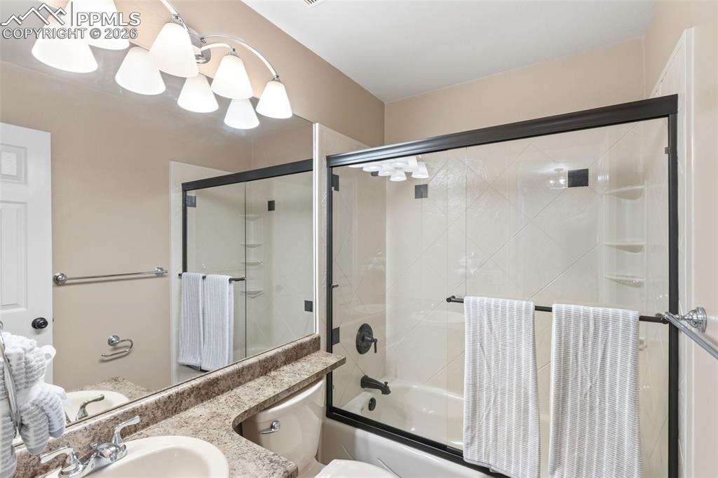 Image 33 of 49: An upper full bath at the end of the hall.