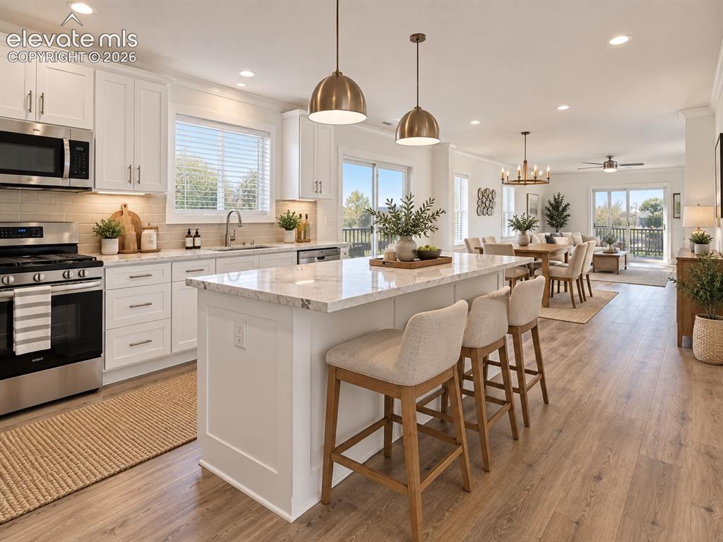 Image 10 of 47: Kitchen & Dining Area – Generous center island provides ample prep space an