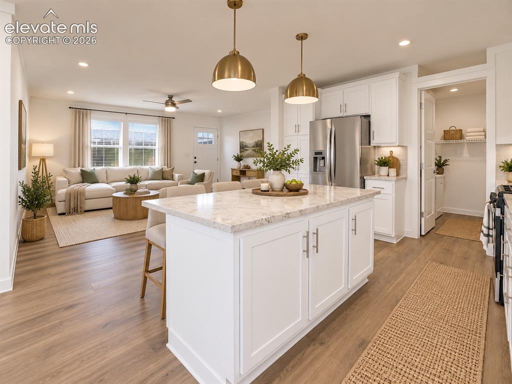 Image 13 of 47: Kitchen & Living Area – Expansive kitchen island anchors the open-concept m