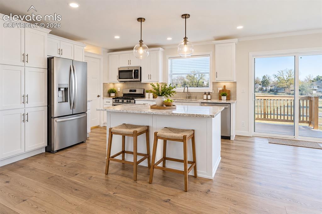 Image 16 of 47: Kitchen – Well-appointed kitchen features a large center island with seatin
