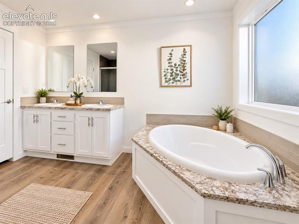Image 28 of 47: Primary Bathroom – Spacious primary bath features a double-sink vanity, soa