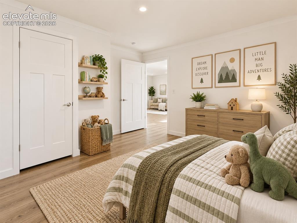 Image 33 of 47: Bedroom – Spacious secondary bedroom offers wide-plank flooring, recessed l