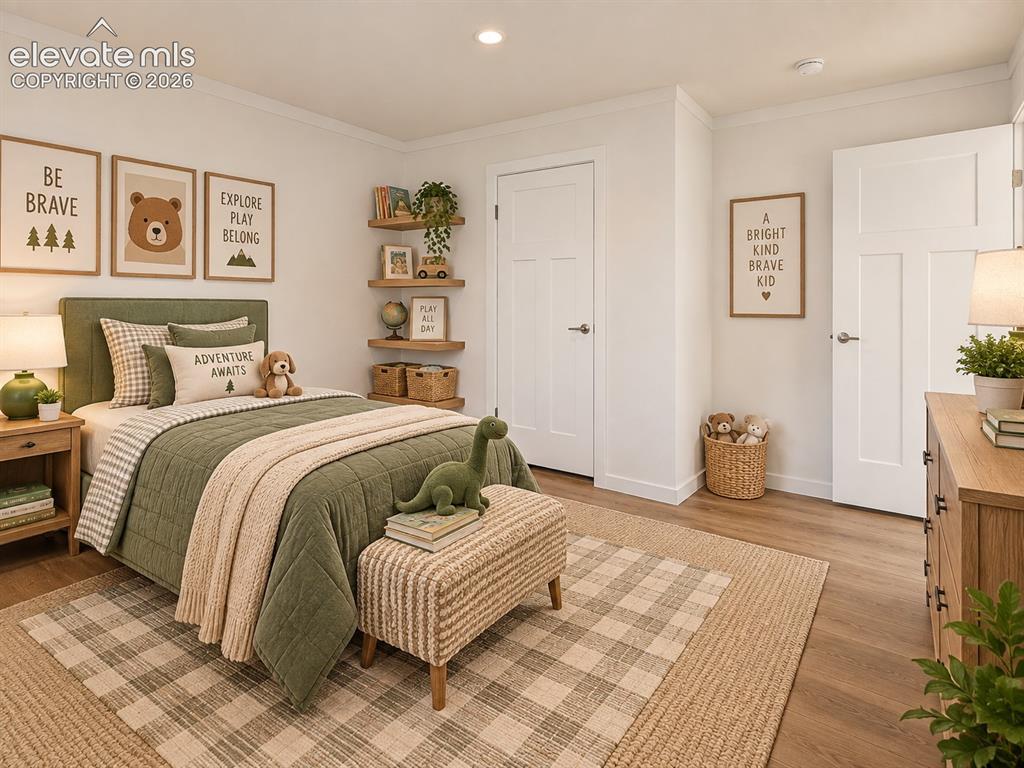 Image 34 of 47: Bedroom – Another well-proportioned secondary bedroom features wide-plank f