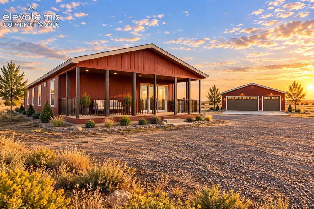 Image 41 of 47: Exterior – Angled exterior view emphasizes the expansive covered porch and
