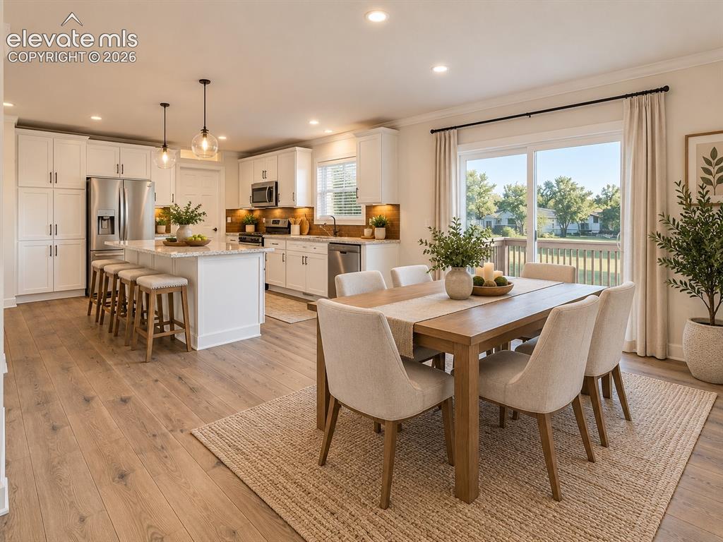 Image 6 of 47: The kitchen and dining spaces come together in an inviting open layout, wit