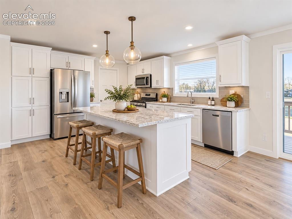 Image 9 of 47: Another view highlights the generous island, abundant cabinetry, stainless 