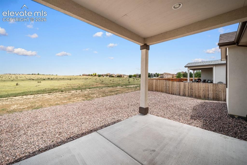 Image 19 of 25: Covered patio with recessed lighting, concrete slab, gravel landscaping, an