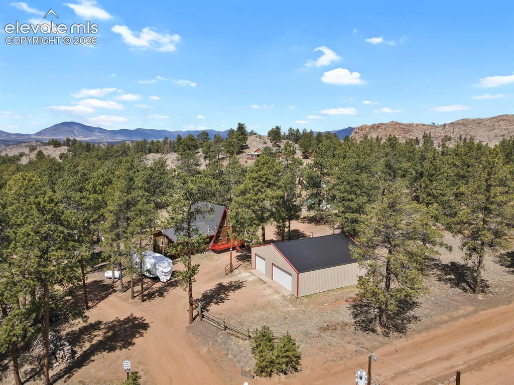 Image 1 of 46: Circular driveway leading to home and detached workshop