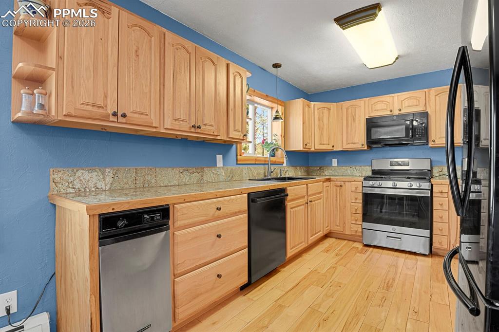 Image 8 of 46: Main level adjoining kitchen and overlooking back deck