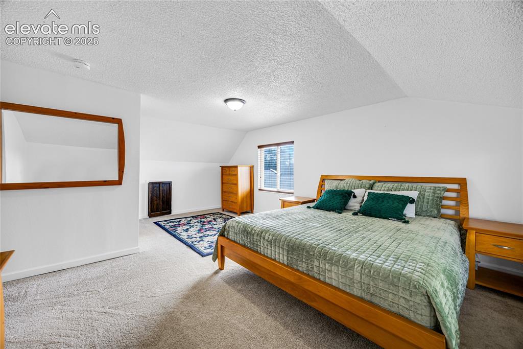 Image 10 of 24: Primary bedroom with attached bathroom upper level