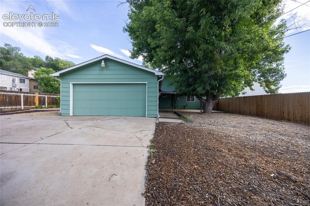 Image 20 of 24: Large backyard with double car attached garage