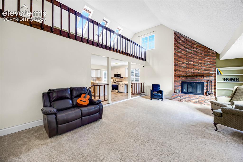 Image 4 of 24: Living room with wood-burning fireplace