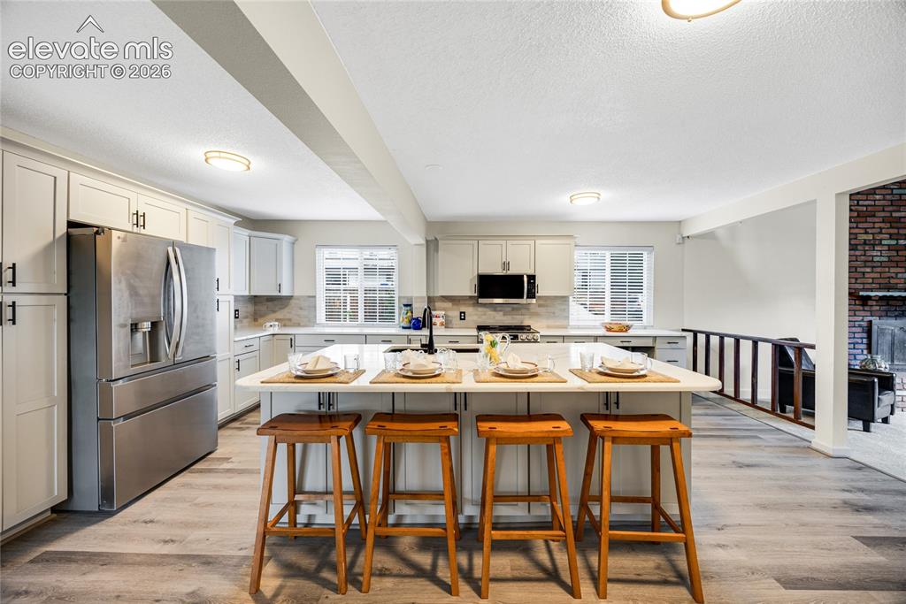 Image 7 of 24: Huge island with gorgeous countertops