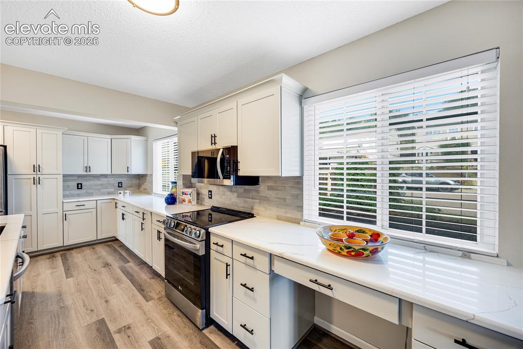 Image 8 of 24: Plenty of counter space in the kitchen with stainless steel appliances