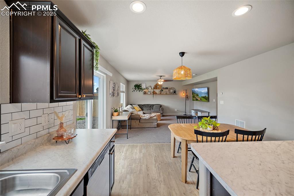 Image 5 of 18: Carpeted dining space with ceiling fan, visible vents, and baseboards