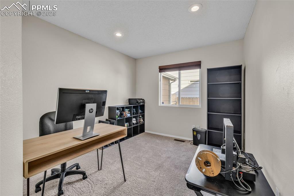 Image 22 of 40: Office area featuring carpet, recessed lighting, and a textured ceiling
