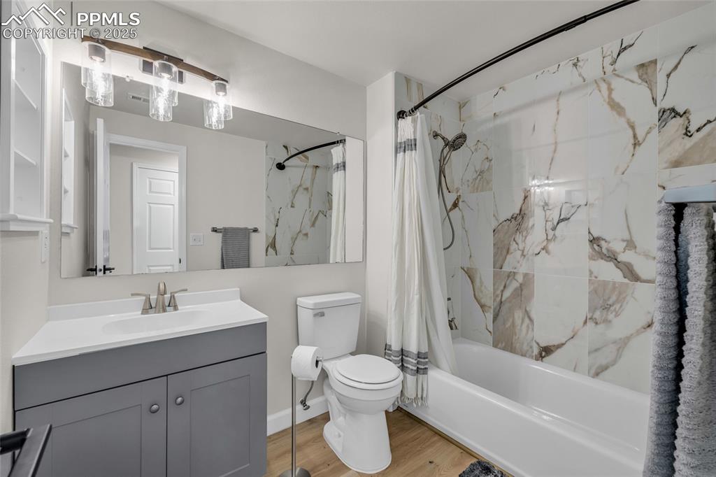Image 27 of 40: Full bathroom featuring a combined bath / shower with marble appearance, va