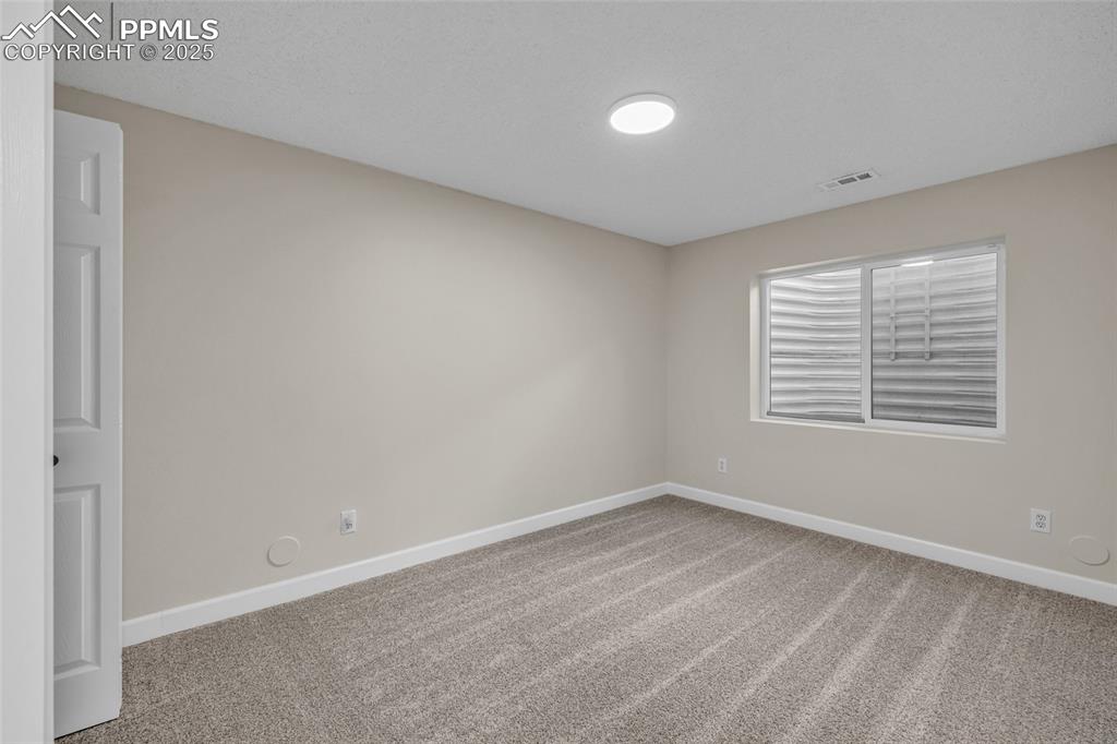 Image 29 of 40: Carpeted spare room featuring baseboards