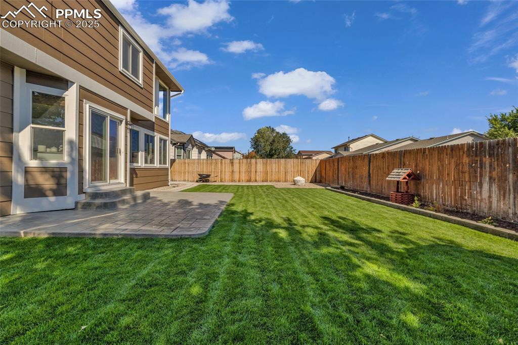 Image 35 of 40: Fenced backyard featuring a patio area