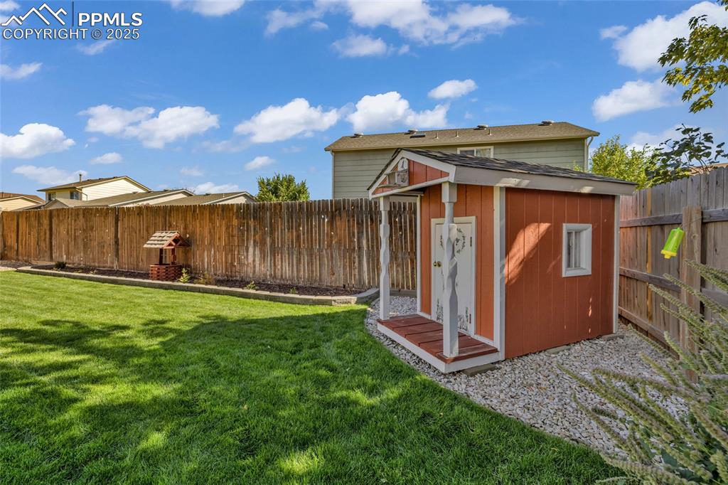 Image 36 of 40: View of shed with a fenced backyard