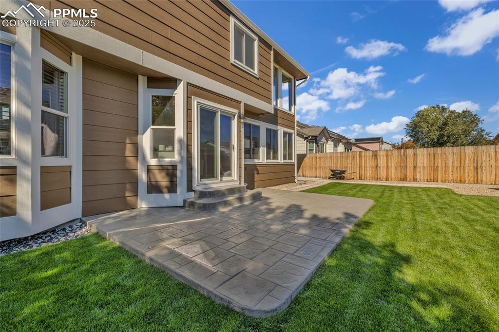 Image 37 of 40: Rear view of house with a patio