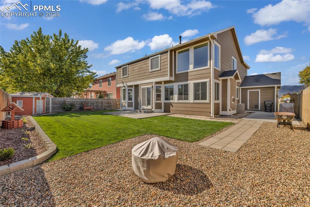 Image 38 of 40: Back of house featuring a patio, a sunroom, and a fenced backyard