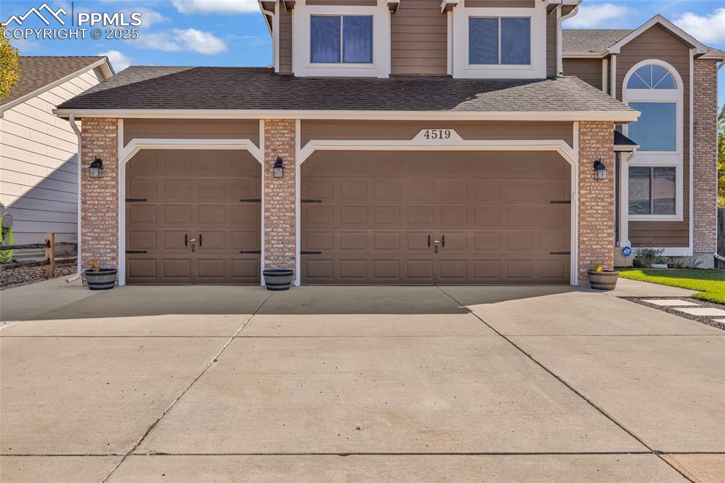 Image 40 of 40: Garage with driveway