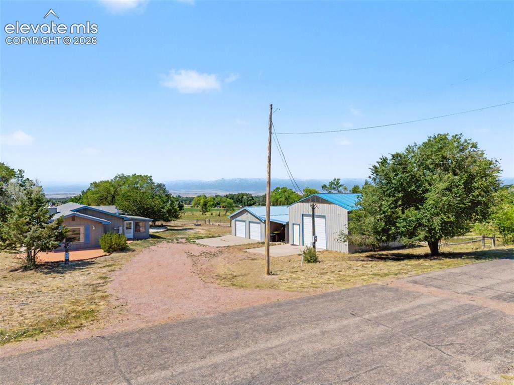 Image 14 of 50: Shed w/ electricity, 2-car garage, carport, RV garage/workshop.