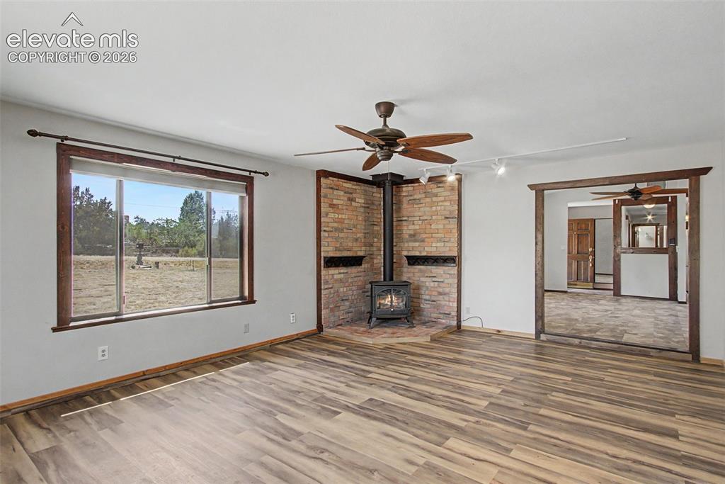 Image 18 of 50: Large family room with big picture window, built-in benches w/ storage, and