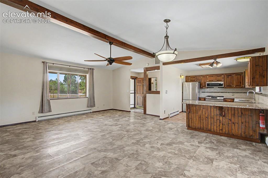 Image 20 of 50: Large great room is perfect for a living room area and a dining area, with