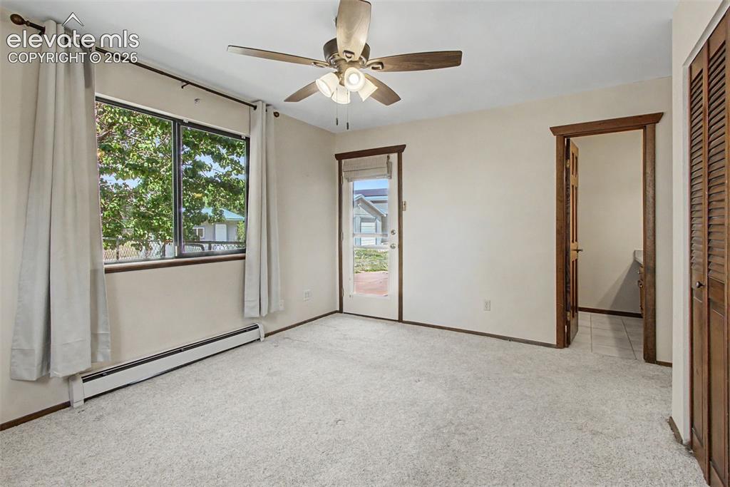 Image 25 of 50: Master bedroom has walk out to side patio and attached bath.