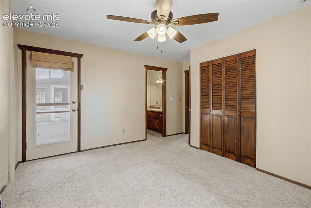 Image 26 of 50: Master bedroom has walk out to side patio and attached bath.