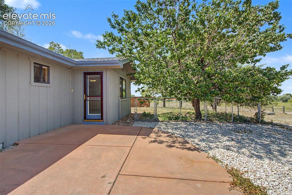 Image 34 of 50: Large patio with fenced side yard, perfect for pets!