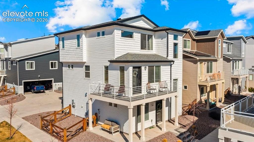 Caption: Modern two-story residence featuring clean-lined architectural design with gabled roofline, light-co