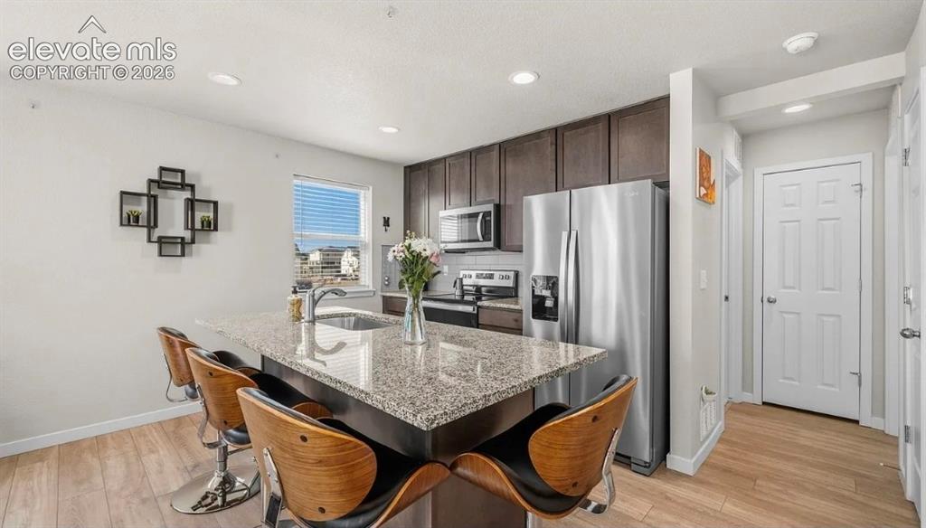 Image 8 of 22: Modern kitchen featuring stainless steel appliances, a large center island 