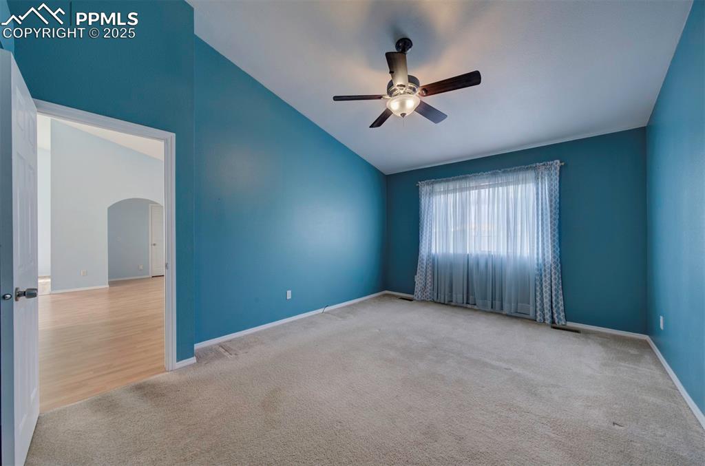 Image 15 of 30: Ceiling Fan, carpet, walk in closet, adjoining bathroom