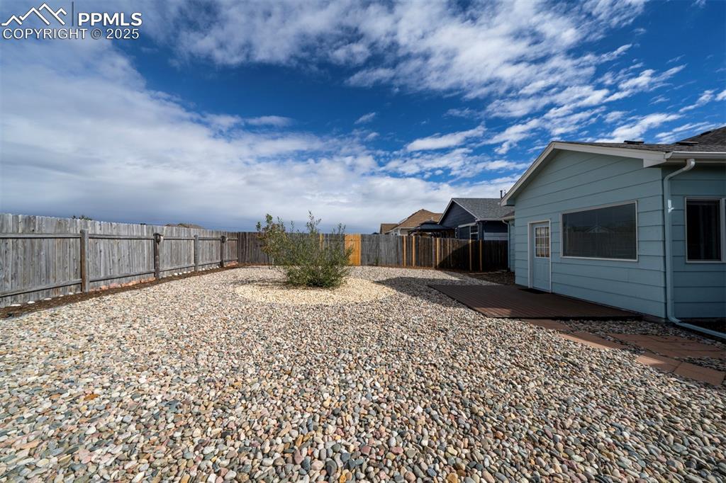Image 29 of 30: Fenced backyard featuring a deck