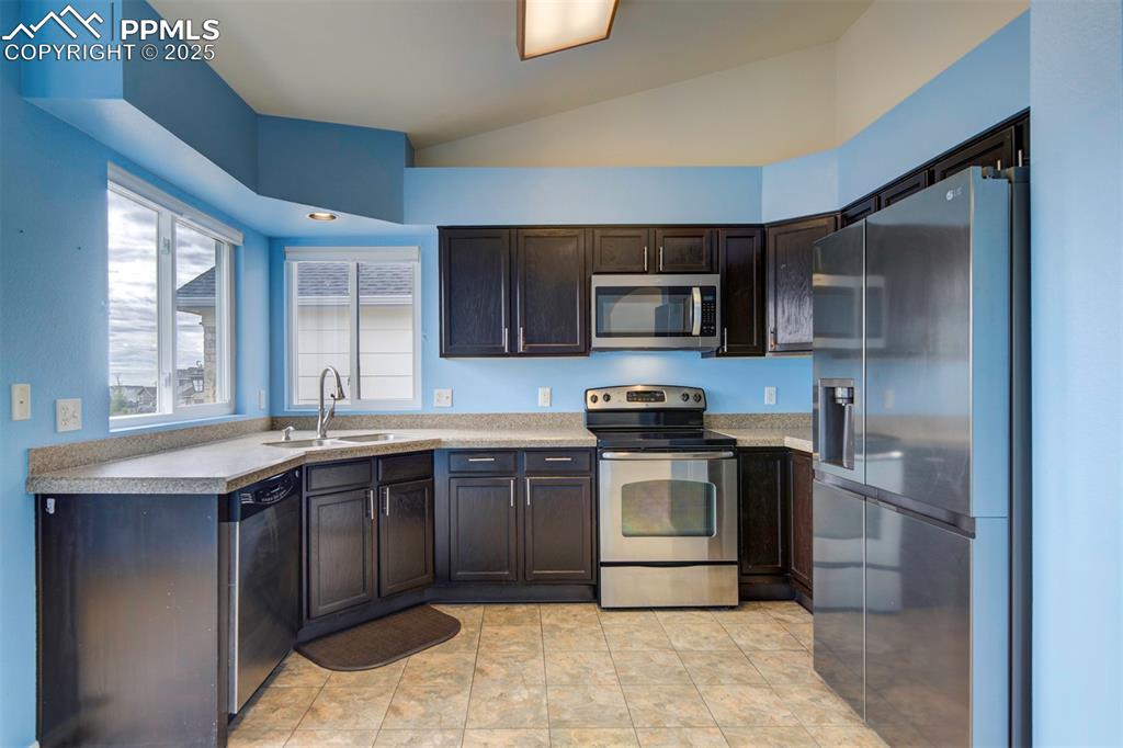 Image 6 of 30: Stainless steel appliances, granite counter tops, dark brown cabinets, pant