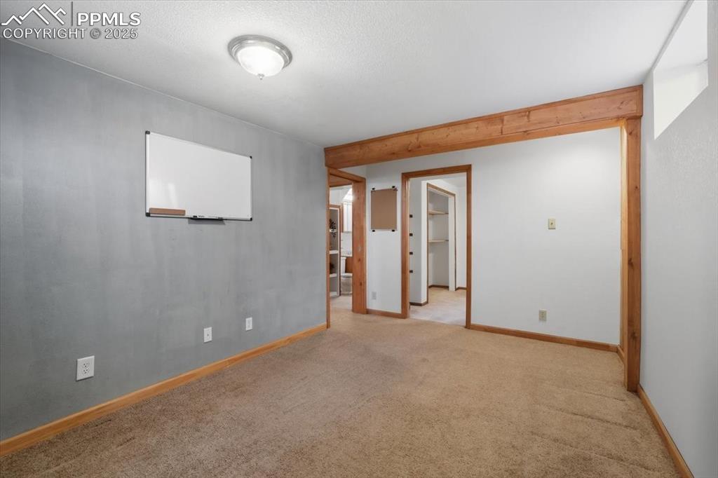 Image 17 of 30: Empty room with carpet floors and a textured ceiling