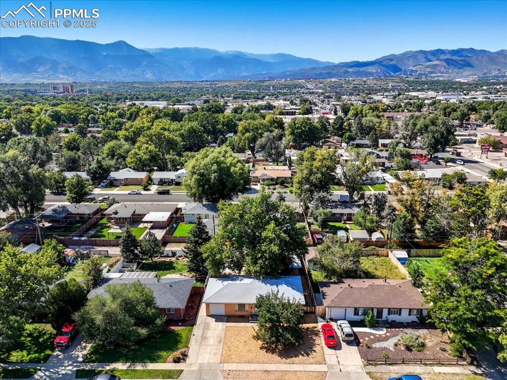 Image 27 of 30: Aerial view of residential area with mountains