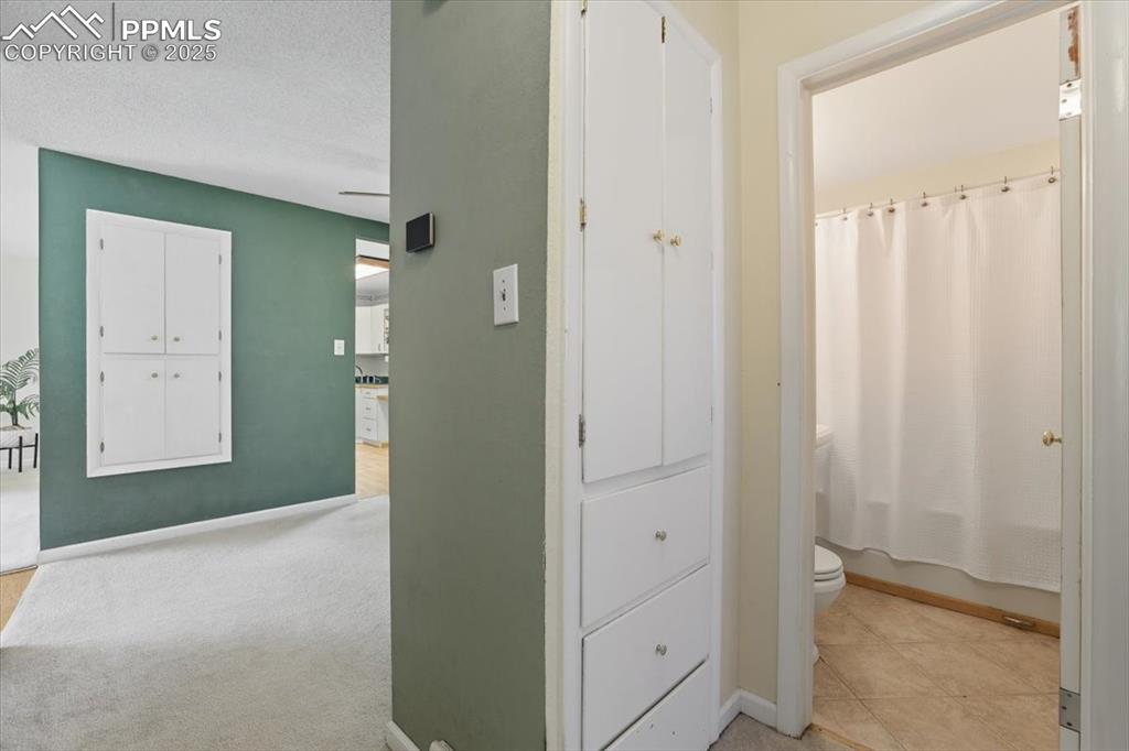 Image 8 of 30: Hall featuring a textured ceiling and baseboards