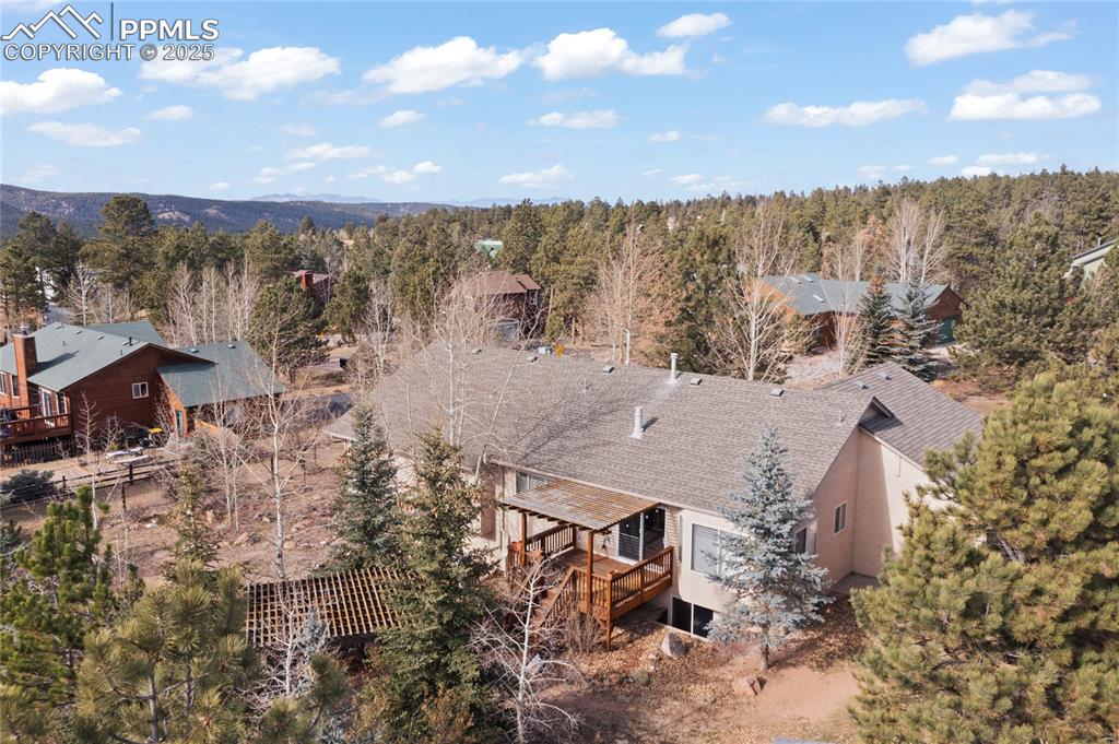 Image 10 of 50: Back yard features a pergola and covered rear deck. There is a perfect view