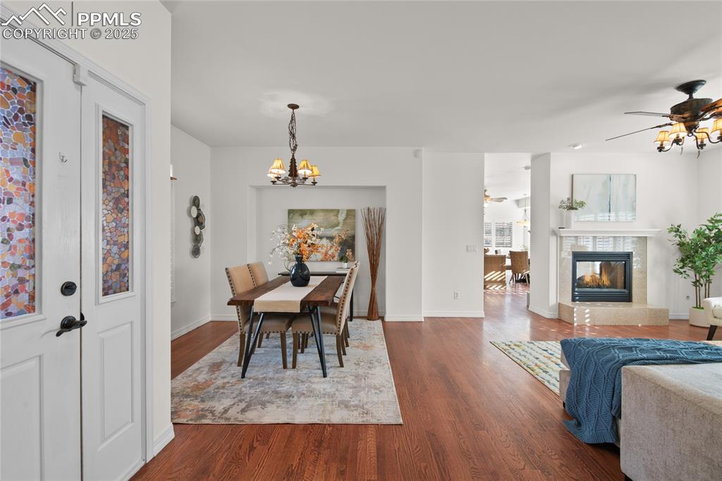 Image 12 of 50: A large dining / living room greets you when you enter the home. Real hardw