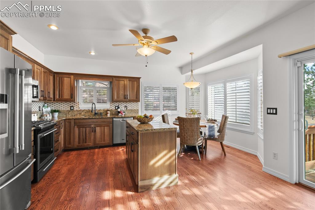 Image 21 of 50: Hard wood floors. Walkout to the back deck. Views of Pikes Peak. Remodeled 