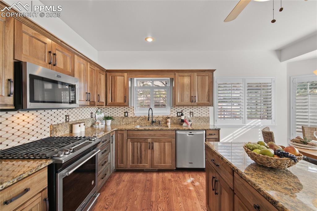 Image 23 of 50: Hard wood floors. Walkout to the back deck. Views of Pikes Peak. Remodeled 