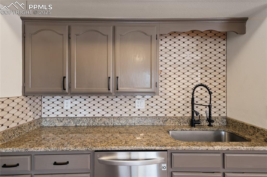 Image 39 of 50: Second full kitchen in the basement. Stainless appliances. Granite counters