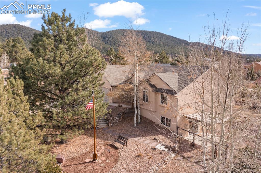 Image 6 of 50: Fully landscaped front yard with custom flag pole. There is access to the f