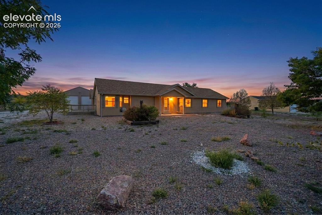 Image 1 of 50: Single-story residence featuring a neutral-toned exterior, gabled roofline,