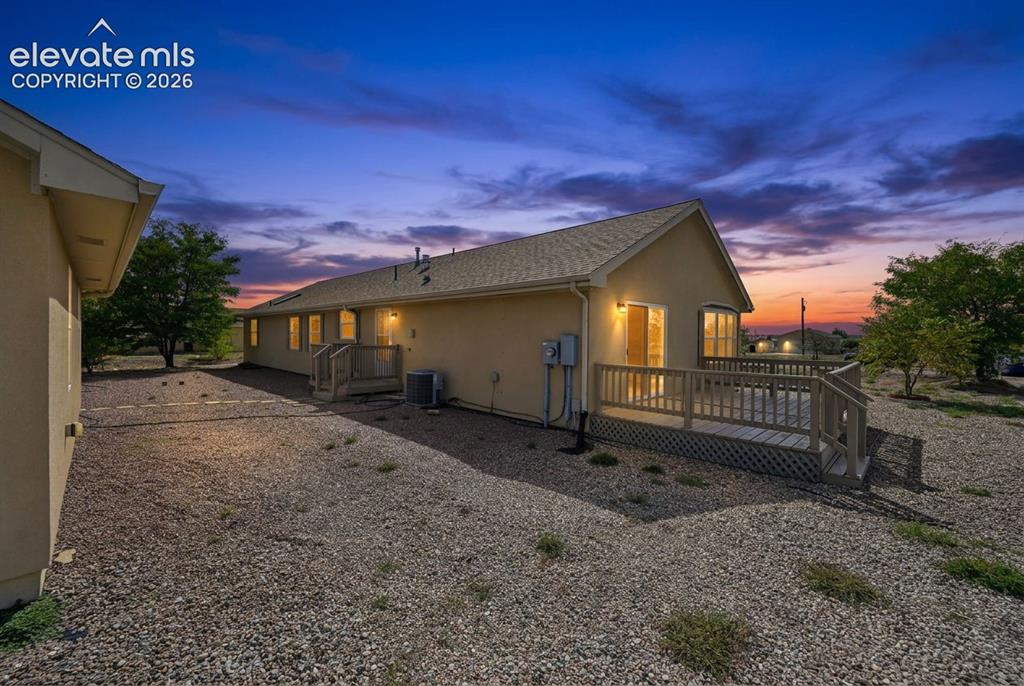 Image 2 of 50: Exterior of a residential property featuring stucco siding, a shingled roof